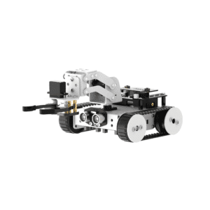 The image shows a small, white robotic vehicle with a claw-like appendage at the front. The robot is tracked, meaning it moves using continuous treads rather than wheels. The body appears to be constructed from modular components, suggesting it may be a kit or easily customizable. The front claw suggests a grasping or lifting function. The robot also appears to have sensors mounted on the front. Overall, it appears to be a small, educational or hobbyist robot designed for tasks requiring manipulation and movement.